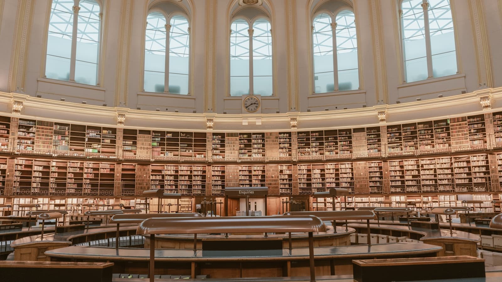 Concentric tiers of bookshelves rising around a grand circular library reading room